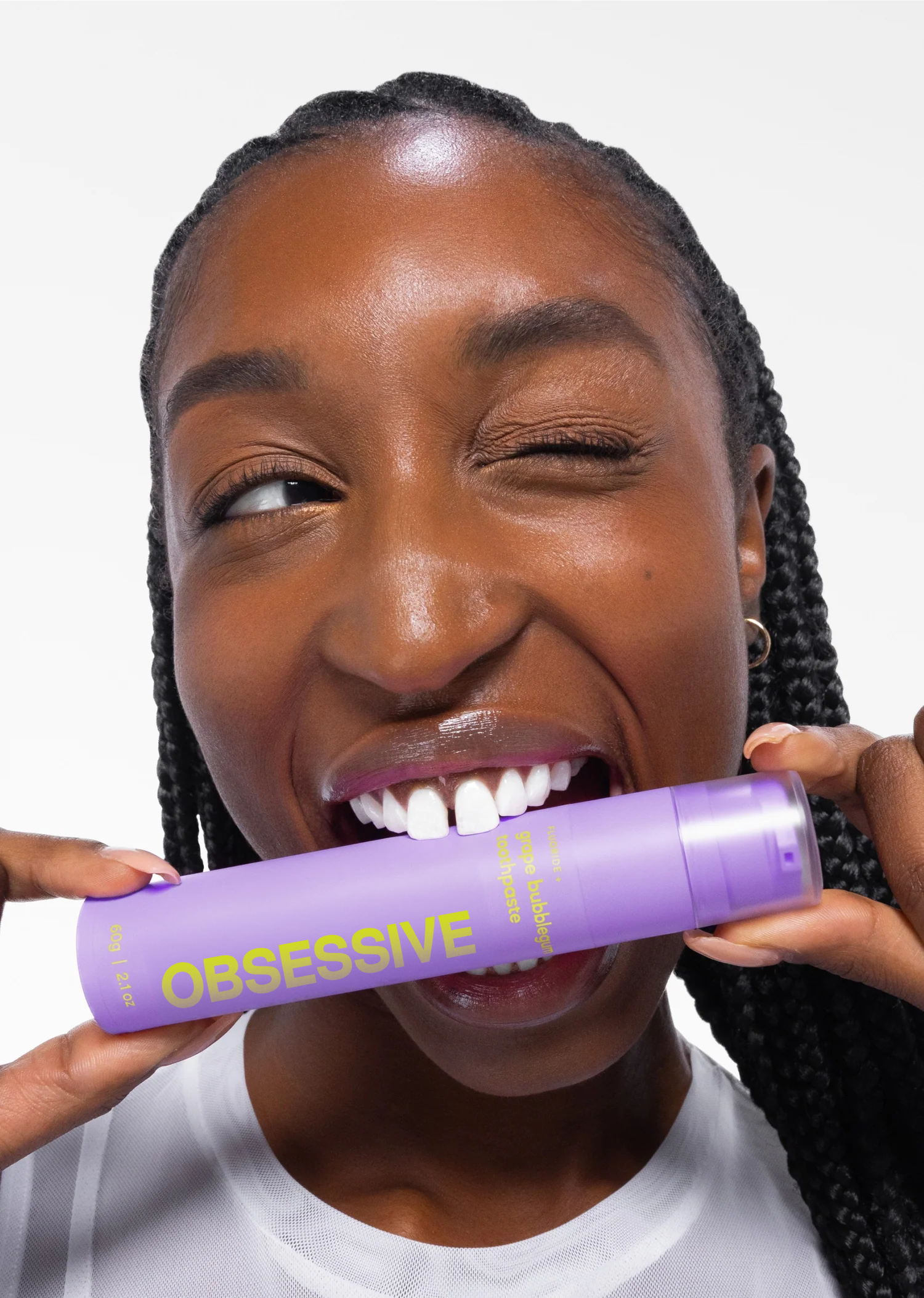 A person applying Purple V34 dental care product to their teeth